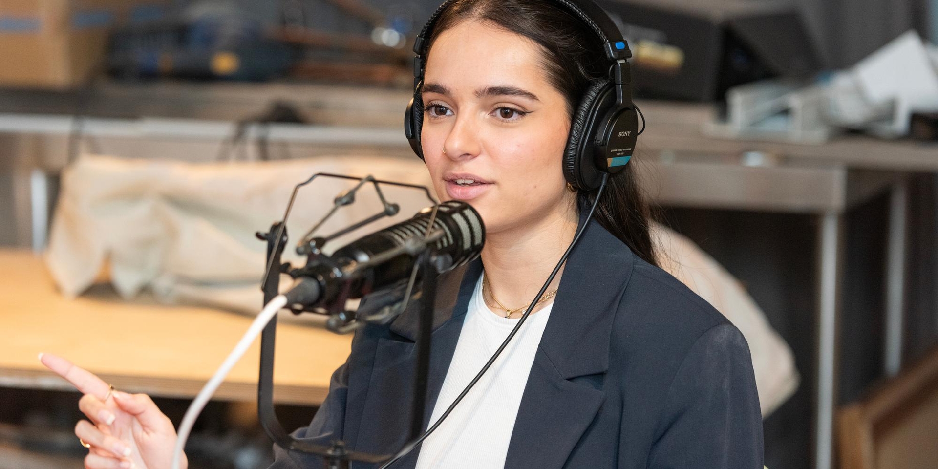 Grace Hardy speaks into microphone while recording her podcast